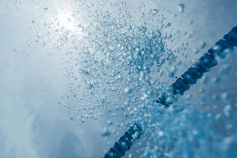 Danger of Drowning Concept with Air Bubbles and rays of Sun Light Stock Photos
