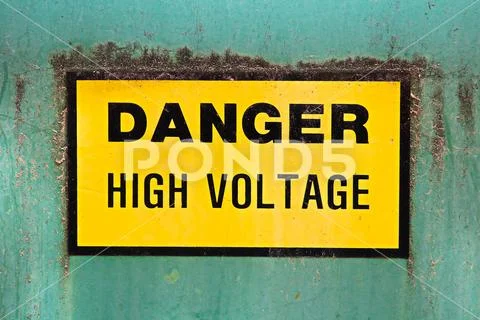 A danger high voltage sign on a green background Stock Photos