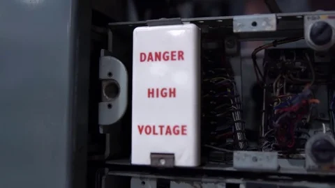 Danger high voltage sign. Old telephone dial station Stock Footage 77649332