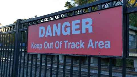 Danger keep out of track area sign red slow move Stock Footage 118463935