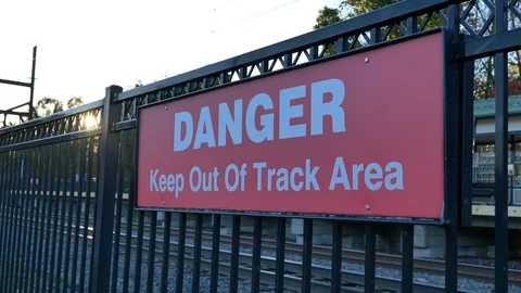 Danger keep out of track area sign sun reveal Stock Footage 118463981