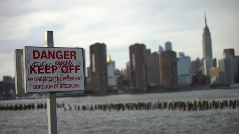 Danger Keep Off Sign East River NYC - Handheld Stockbeeldmateriaal 170782646