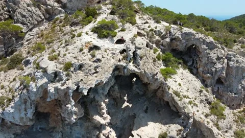 Danger, man climbs into cave.
Daring aerial view flight fly forward drone Video stock 202617818