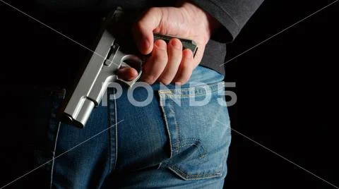 Danger man with a pistol behind the back Stock Photos
