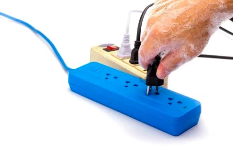 The danger of plugging in electricity while your hands are still wet. May cau Fotos de archivo