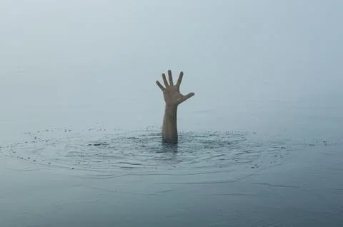 Danger, problems, risk concept. Close up of human hand drowning in the lake Stock Photos