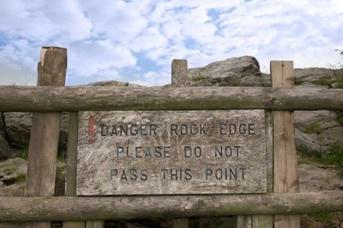 Danger rock edge please do not pass this point sign Stock Photos
