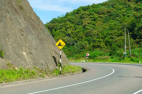 Danger of rocks falling from the mountain to the road Stock Photos