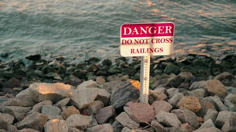 Danger Sign, Do Not Cross, Riverside, Wave,Sunset, 4K30p Stock Footage 305127795