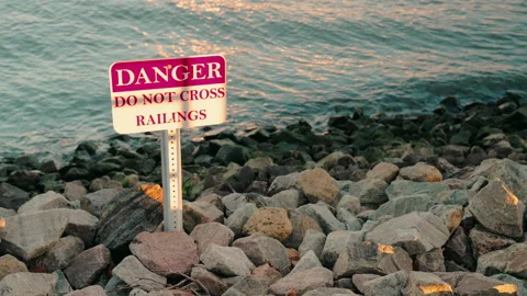 Danger Sign, Do Not Cross, Riverside, Wave,Sunset, 4K30p Stock Footage 305127807
