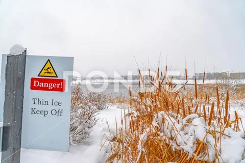 Danger sign near a snowy lake in Daybreak Utah Stock Photos
