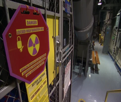 Danger sign outside locked high radiation area in nuclear power plant Stock Footage