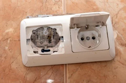 Dangerous broken electrical socket. Broken outlet. Stock Photos