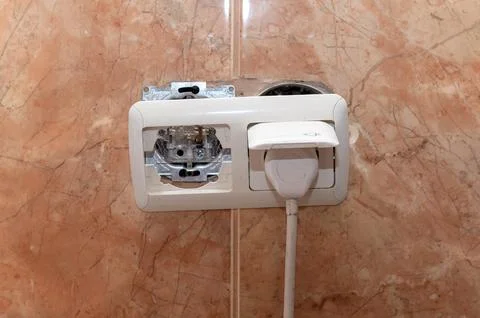 Dangerous broken electrical socket. Broken outlet. Stock Photos