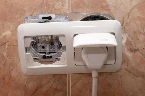 Dangerous broken electrical socket. Broken outlet. Stock Photos