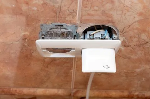 Dangerous broken electrical socket. Broken outlet. Stock Photos