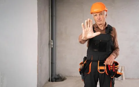 Dangerous on building concept. Elderly Builder with stop gesture and no hand Stock Photos