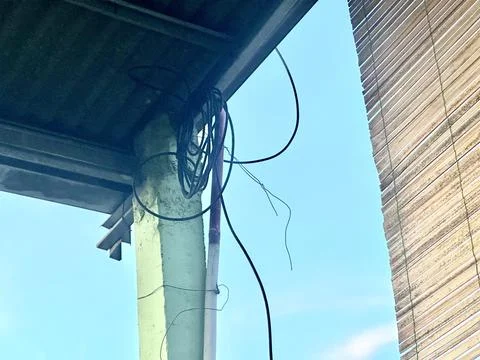 Dangerous cable at the ceiling of a house Stock Photos