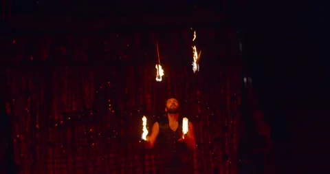Dangerous circus performance, a man is juggling lit torches, 4k Stock Footage 147191235