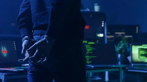 Dangerous computer hacker arrested by cyber security forces in the office at Foto stock