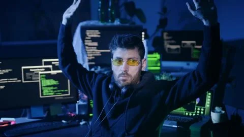 Dangerous computer hacker caught in the act of cyber crime in the company office Foto stock