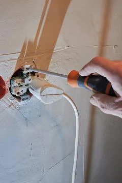 Dangerous connection of an electrical plug to a new socket without a decorative Stock Photos