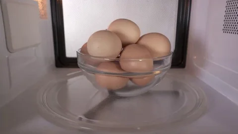 Dangerous cooking eggs in the shell in a microwave oven Video stock 69181931