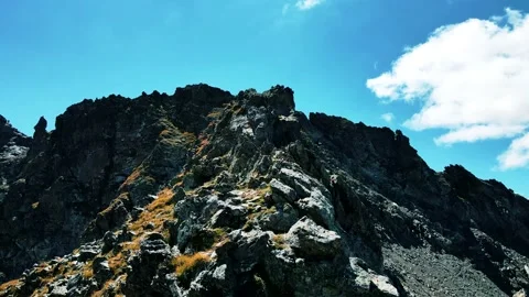Dangerous drone flight over the sharp cliffs of the mountain top Stock Footage 138441968