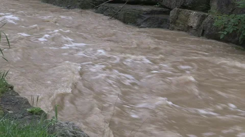 Dangerous fast flowing river water and dam conditions after heavy thunderstorm Stock Footage 40056334