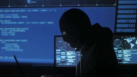 Dangerous hacker in the mask tries to enter the system using codes and numbers Stock Footage 86894315