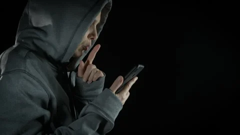 Dangerous hacker using smartphone on black. Stock Footage 307908659
