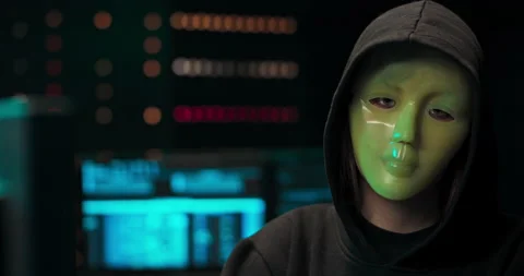 Dangerous Internationally Wanted Hacker with Masked Face Speaks into the Camera Stock Footage 146053275
