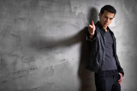 Dangerous man posing at the Studio wall Stock Photos