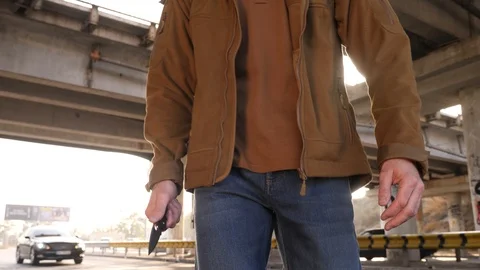 Dangerous man pulls knife, walks forward Stock Footage 118402185