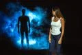 The dangerous man in smoke following the woman in the dark street Photo