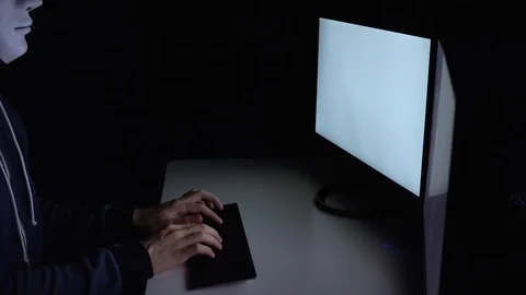 Dangerous masked hacker using a computer for cyber attack, phishing, hacking Stock Footage 93224705