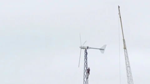 Dangerous profession. Work climbs the tower to the wind generator Stock Footage 71091091