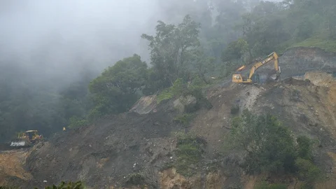 Dangerous road construction in misty cloud forest Stock Footage 123556452