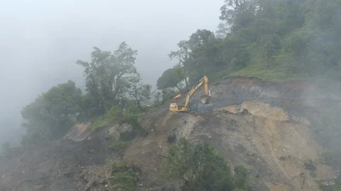 Dangerous road construction in misty cloud forest Stock Footage 123556455