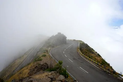 Dangerous road curve with fog Stock Photos