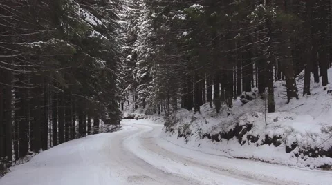 Dangerous road trip by car on mountain trails in the snow Stock Footage 59159108