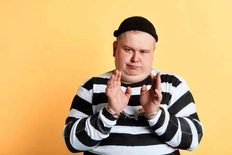 Dangerous robber in handcuff posing to the camera Stock Photos