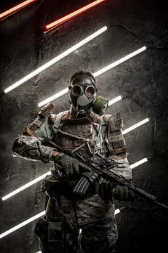 Dangerous soldier with gas mask against dark background Stock Photos