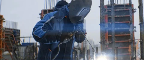 Dangerous welding work on roof of multi-storey building under construction Stock Footage 119496727