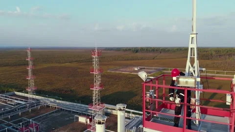 Dangerous work at heights An installer performs work on a high metal tower. Work Stock Footage 154967229