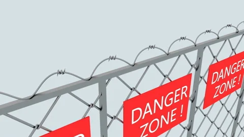 Dangerous zone. The camera moves slowly along a metal fence with barbed wire Stock Footage 128303443