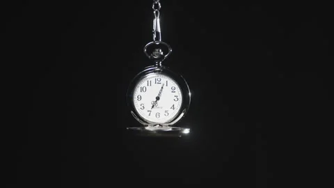 Dangling stop watch in a black void. 5 minutes pass in timelapse. Stock Footage 342880519