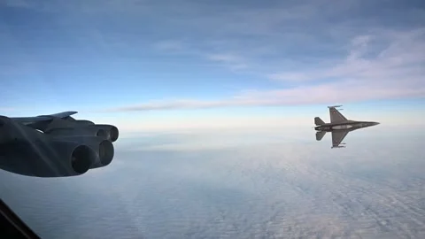 Danish Air Force F-16 Fighting Falcon peels away from U.S. Air Force B-52 Bomber Stock Footage 292778286