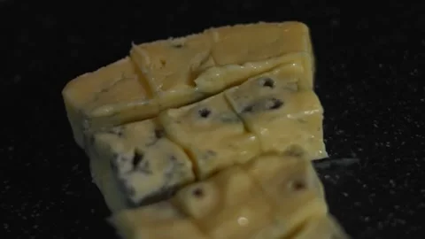 Danish blue cheese cubes on a cutting board. 4K video. Top view Stock Footage 146488885