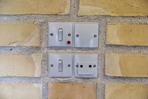 Danish Electrical Switches and Socket on Brick Wall Stock Photos